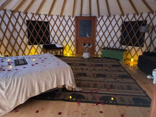 a room with a bed and a large rug in a yurt at Mountain Retreat on Private Lake-Alderbrook Lodge in Bolton