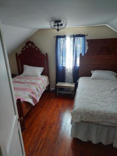 a bedroom with two beds and a window at 5BR Home - Pets Allowed by ARK Experience in Williamstown