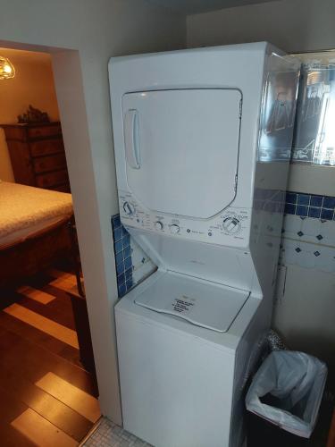 a white refrigerator with its door open in a kitchen at 5BR Home - Pets Allowed by ARK Experience in Williamstown