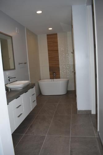 a bathroom with a tub and a sink and a bath tub at Ocean View Home Mision Viejo KM50 Gated Security in Rosarito