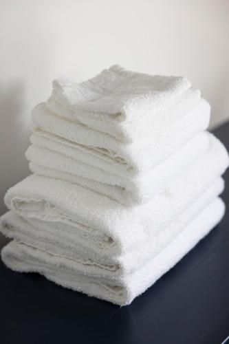 a stack of white towels sitting on a table at American Hotel in Los Angeles