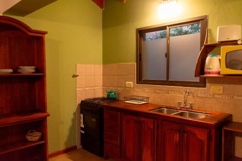 a kitchen with a sink and a counter top at La Cuyanita - Complejo de cabañas in Merlo