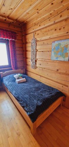 a bedroom with a bed in a log cabin at Góralska Chata & Spa in Muszyna