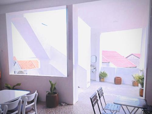 a room with a table and chairs and a large window at Anna homestay- Đông Tác, Tuy Hoà, Phú Yên in Ðông Tác (1)