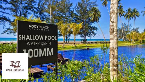 a sign in front of a swimming pool at a resort at Sematan SeaView Apartment,Highest Floor in Sematan