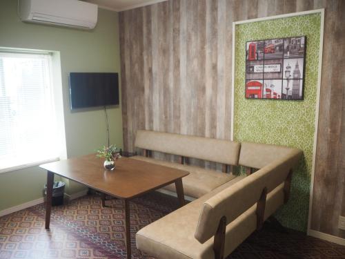 a living room with a couch and a table at Midtown Inn in Niigata