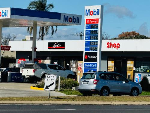 a car parked in front of a mobil gas station at Town and Country Motor Inn in Tamworth