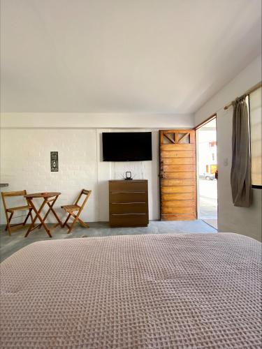 a bedroom with a bed and a flat screen tv at Casa Danda Punta Hermosa in Punta Hermosa