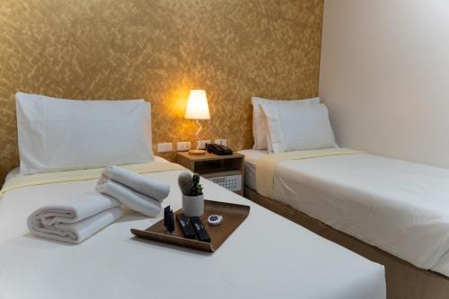 Postel nebo postele na pokoji v ubytování DCCCO Hotel