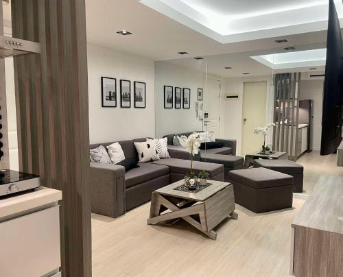 a living room with a couch and a table at High-end 2BR Condo Boracay Tower - Azure Residences near Manila Airport in Manila