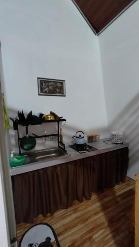 a kitchen with a table with a counter top at Dieng Kilea Homestay in Dieng