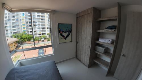 a room with a window and a bed in a room at Ricaurte Apartamento Peñazul nuevo 90mts in Ricaurte