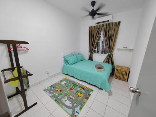 a small bedroom with a green bed and a window at Zanayra Homestay in Melaka