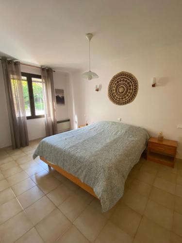 a bedroom with a bed and a large window at Villa "les vacances" in Les Plans