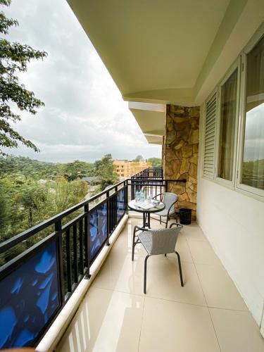 a balcony with a table and chairs on it at Transformer Center Hotel in Batu