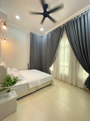 a bedroom with a bed and a ceiling fan at Timeless Cottage KB in Kota Bharu