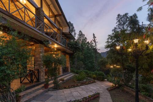 a house with a walkway next to a building at Buransh Terraces Luxury 3&4BHK Villas with Mountain View & Caretaker & Kitchen & Complementary Breakfast in Bhowāli