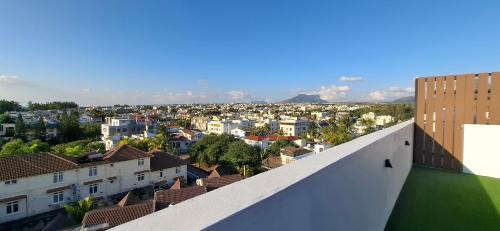 a view of a city from the roof of a building at Seaside Escape Apartment in Flic-en-Flac