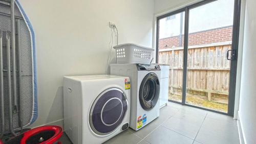 a washing machine and a dryer in a room at Comfort Retreat VIC Officer 5BR WiFi Parking in Officer