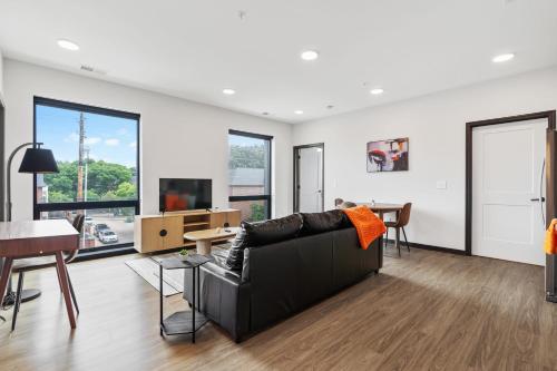 a living room with a couch and a table at CozySuites on Mass with garage parking #10 in Indianapolis