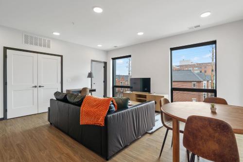 a living room with a couch and a table at CozySuites on Mass with garage parking #10 in Indianapolis
