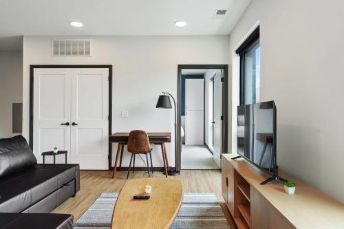 a living room with a couch and a table at CozySuites on Mass with garage parking #10 in Indianapolis