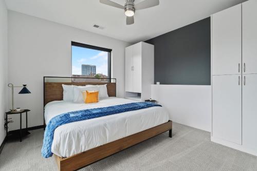 a bedroom with a large bed and a window at CozySuites on Mass with garage parking #10 in Indianapolis