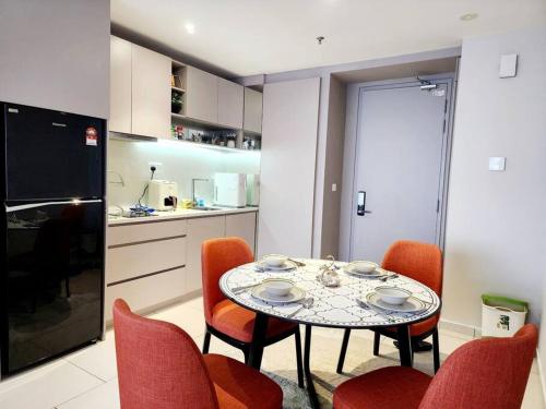 a dining room with a table and chairs and a kitchen at ICity Luxury Corner 2room Hill10 Coway 1parking in Shah Alam