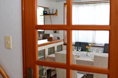 a dining room with a table with wine glasses at HOEI villas Fujisan全景 富士山 河口湖中心区 in Fujikawaguchiko