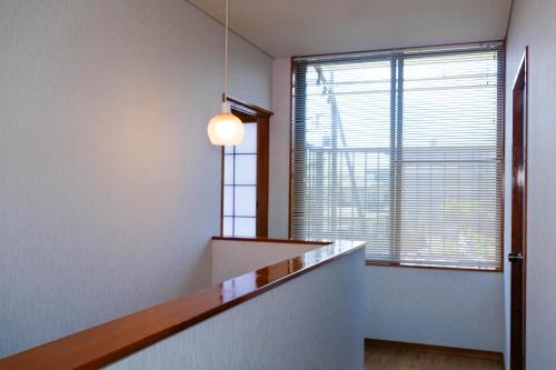 a hallway with a staircase and a window at HOEI villas Fujisan全景 富士山 河口湖中心区 in Fujikawaguchiko