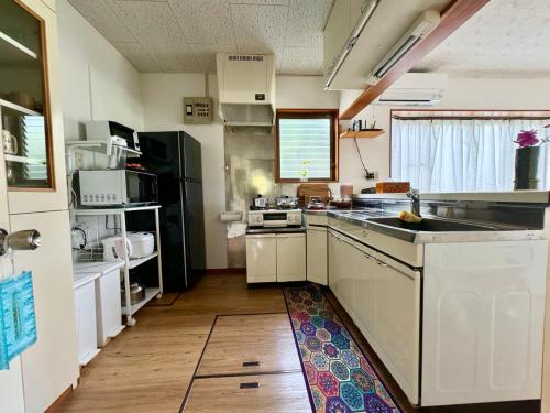 a kitchen with a sink and a stove top oven at HOEI villas Fujisan全景 富士山 河口湖中心区 in Fujikawaguchiko