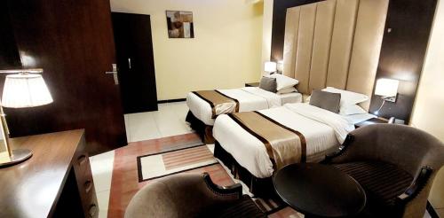Ένα ή περισσότερα κρεβάτια σε δωμάτιο στο Address Sharurah Hotel