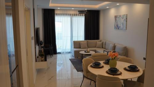 a living room with a couch and a table and chairs at Panorama Suite Hotel in Iskele