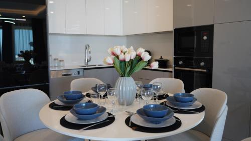 a dining room table with a vase of flowers on it at Panorama Suite Hotel in Iskele