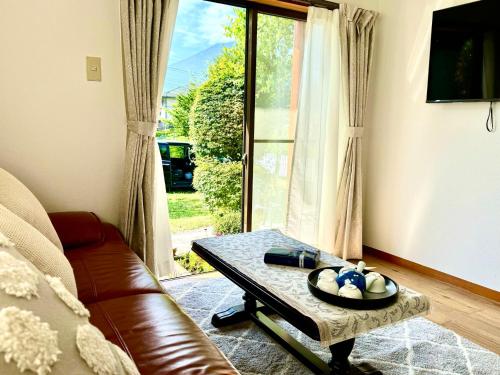 a living room with a couch and a coffee table at HOEI villas Fujisan全景 富士山 河口湖中心区 in Fujikawaguchiko