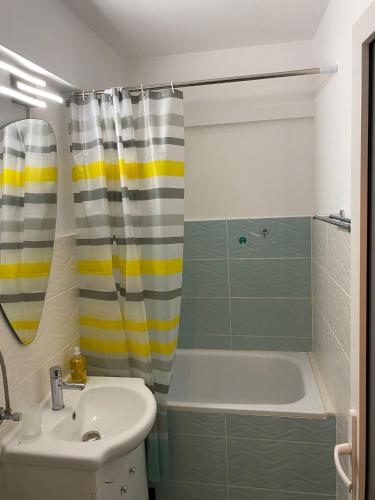 a bathroom with a sink and a tub and a shower at Old Town Apartment in Constanţa