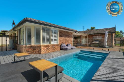 a swimming pool in the backyard of a house at Serene Pet Friendly with Swimming Pool in Culburra Beach