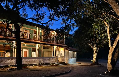 a house with a balcony on the side of it at Funky Leopard Safari Lodge Bordering Yala National Park in Kataragama