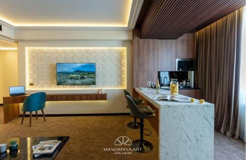 a hotel room with a bar and a kitchen at Mandarinnart HOTEL in Astara