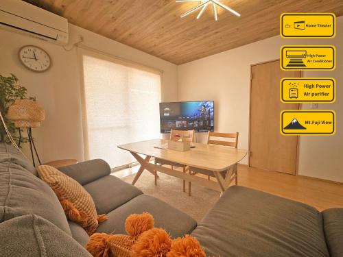 a living room with a couch and a table and signs at ヴィラ山間堂 Terrace Villa BBQ Bonfire Fuji view Annovillas in Fujikawaguchiko