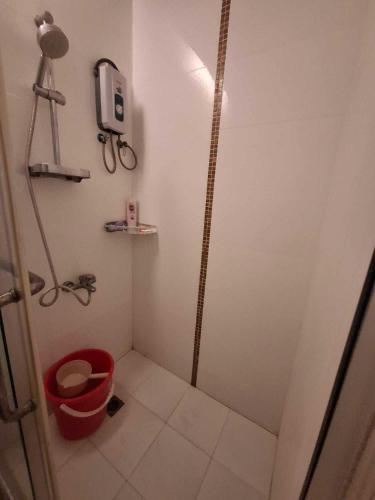 a small white bathroom with a red trash can at Apple One Banawa Heights Cebu City Cheap & High Quality in Cebu City