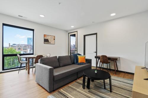a living room with a couch and a table at CozySuites on Mass with garage parking #7 in Indianapolis