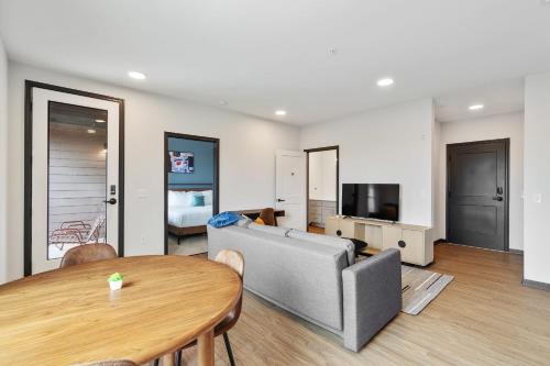 a living room with a couch and a table at CozySuites on Mass with garage parking #7 in Indianapolis