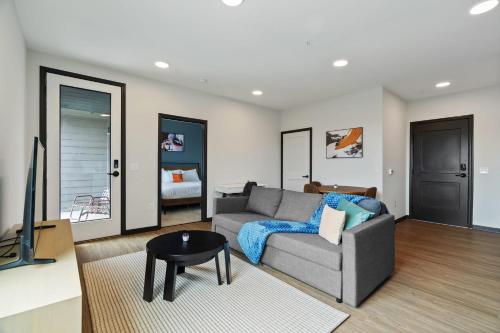 a living room with a couch and a television at CozySuites on Mass with garage parking #8 in Indianapolis