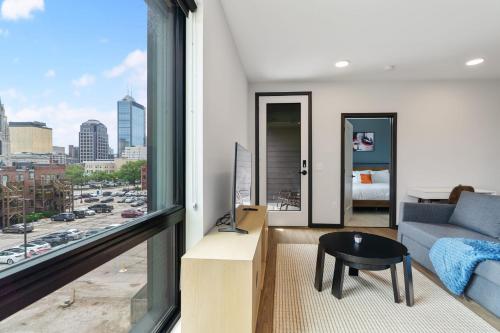 a living room with a view of a city at CozySuites on Mass with garage parking #8 in Indianapolis