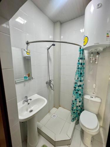 a bathroom with a toilet and a sink at Muhtasham in Bukhara