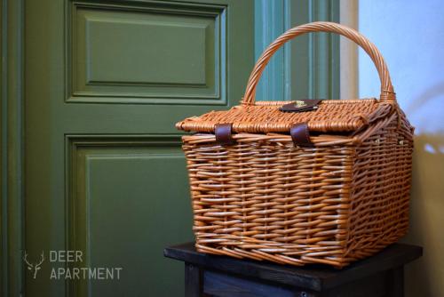 a wicker basket sitting on a table in front of a door at Deer Apartment - exclusive apartment Jihlava in Jihlava