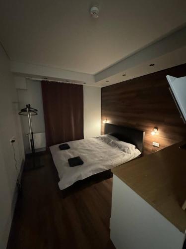 a bedroom with a bed in the middle of it at EksPorta Apartments 6 in Rīga