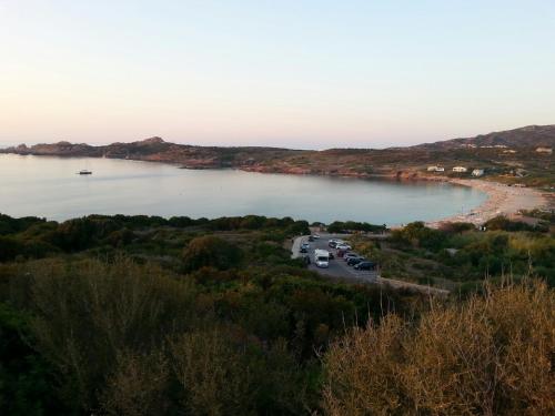a view of a body of water with a beach at Penthouse vista mare in Trinità dʼAgultu