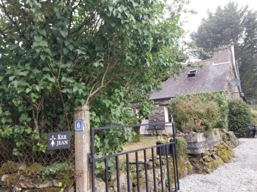 a gate to a house with a sign on it at KerJean in Caurel